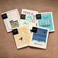 Load image into Gallery viewer, Set of five white quilted cloth scrubbers with colorful prints and black thinking and you tags from the bonus joy rider line