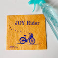 Load image into Gallery viewer, Yellow textured Swedish dishcloth with blue joy rider bicycle design for eco-friendly cleaning gifts