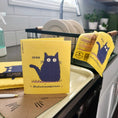 Load image into Gallery viewer, Yellow clards reusable swedish sponge cloth with navy blue cat illustration and shed on me text for cleaning use