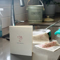 Load image into Gallery viewer, Note Worthy 2-in-1 in use at sink Greeting Clard® turns into reusable cleaning cloth soakitup.shop