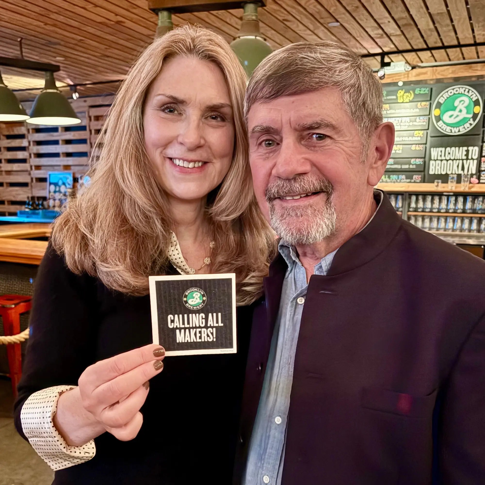 Black square coaster with white text and green brooklyn brewery logo featured in the honors that keep me going article