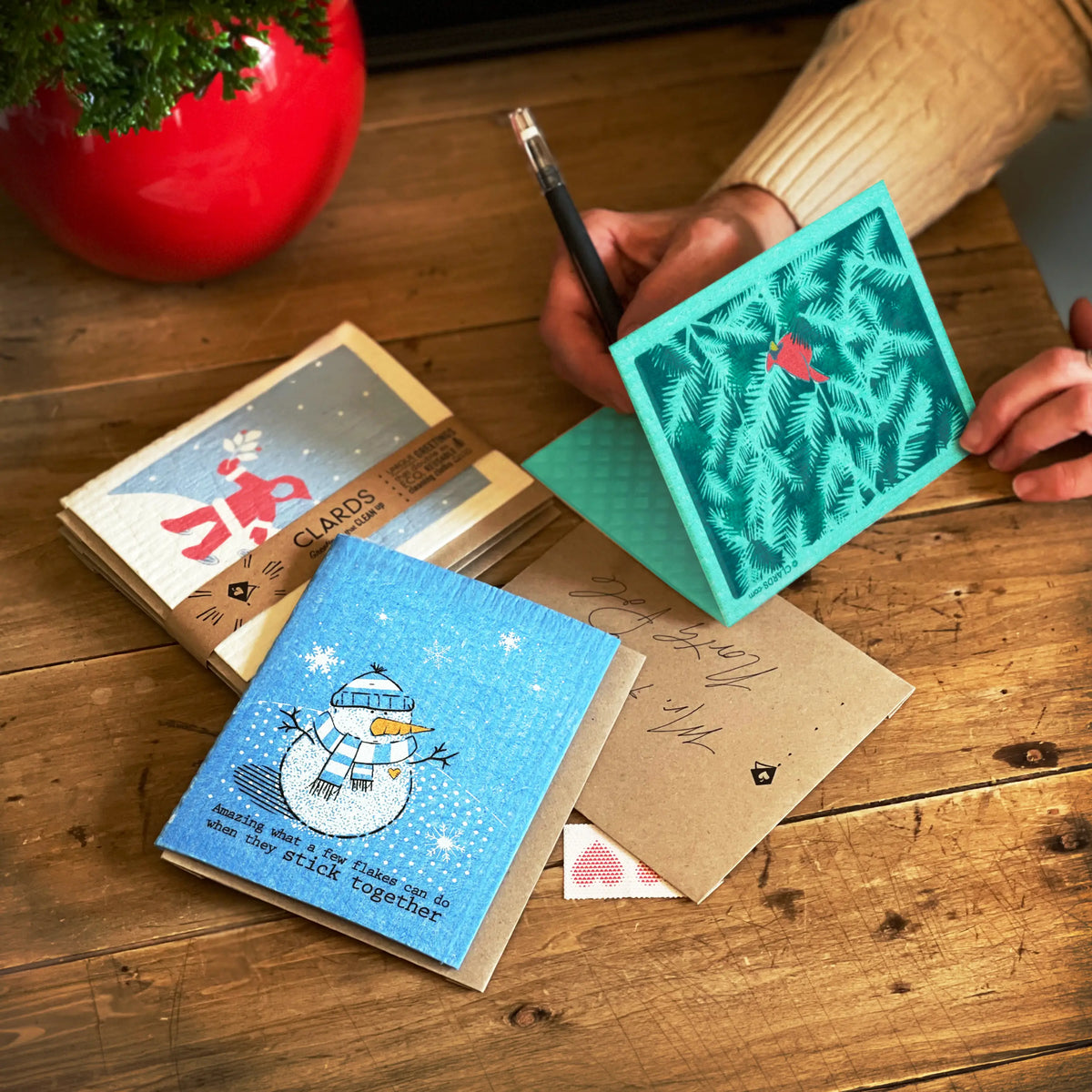 Teal square clards greeting card with a red bird on pine needle pattern perfect for sustainable home bundles