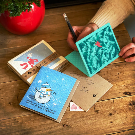 Teal square clards greeting card with a red bird on pine needle pattern perfect for sustainable home bundles