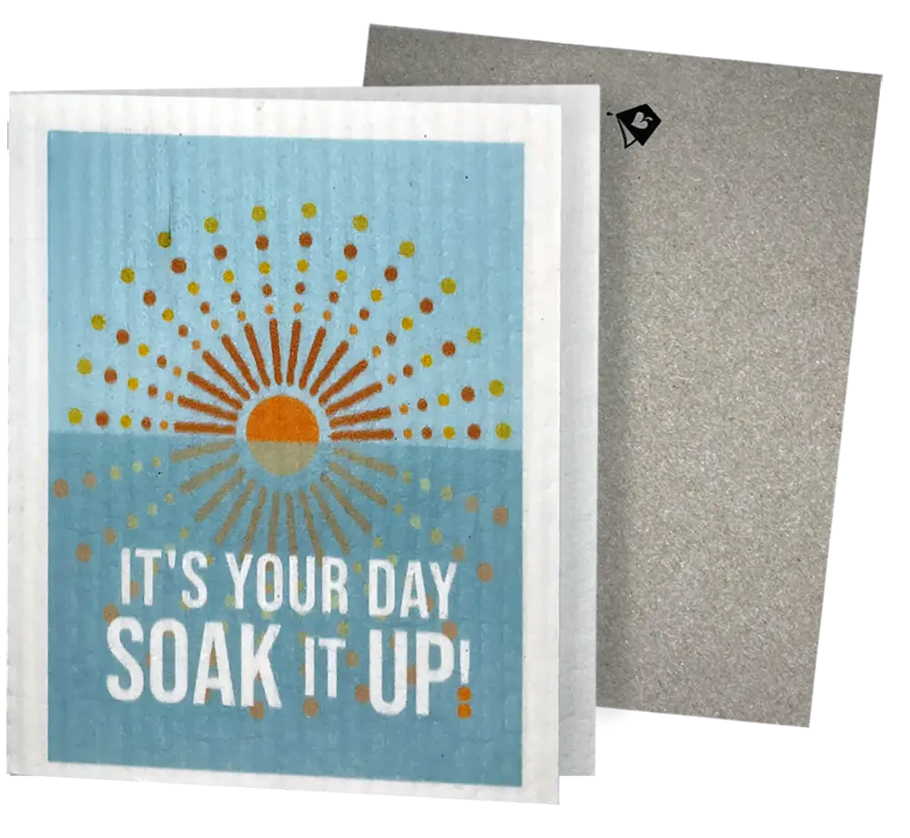Light blue reusable swedish sponge cloth with sunburst design and soak it up text blank inside for cleaning fun