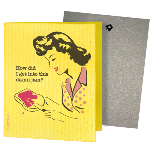 A yellow greeting card with a retro-style illustration of a woman and the text 'How did I get into this damn jam?' next to a kraft paper envelope.