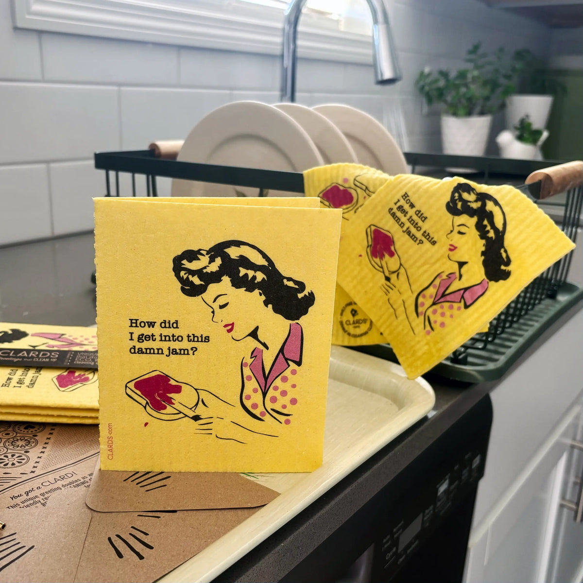 Bright yellow reusable swedish sponge cloth with retro woman holding jam bread from soak iT up clards collection