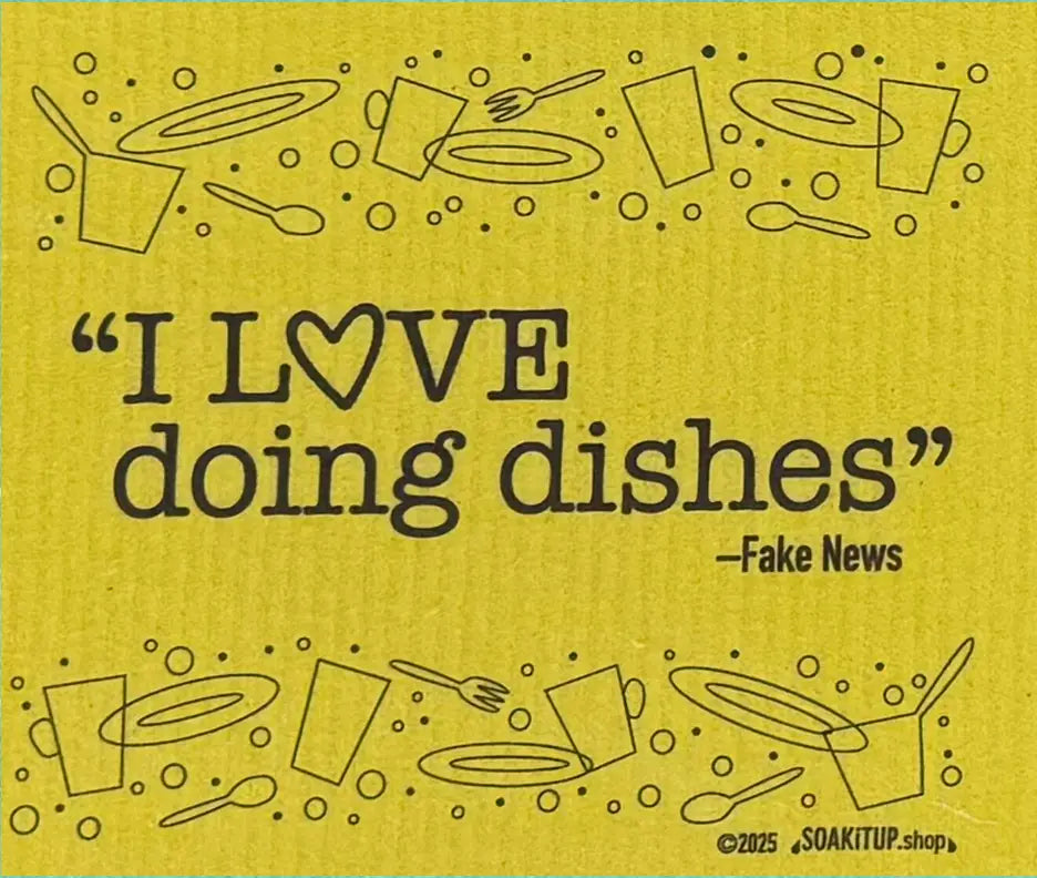 Yellow towel with kitchen utensils and text 'I LOVE doing dishes - Fake News' on a yellow background