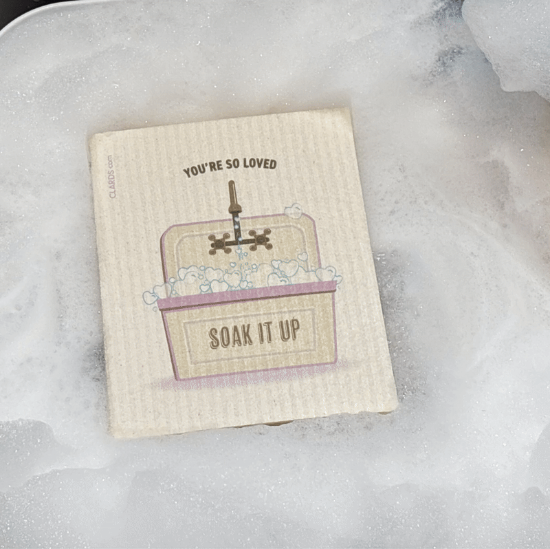 Beige textured reusable swedish sponge cloth with bathtub design and soak it up text from love finds us eco greeting card