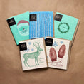 Load image into Gallery viewer, Set of five holiday cards with festive santa deer and mittens designs on textured paper for joy rider cloth use
