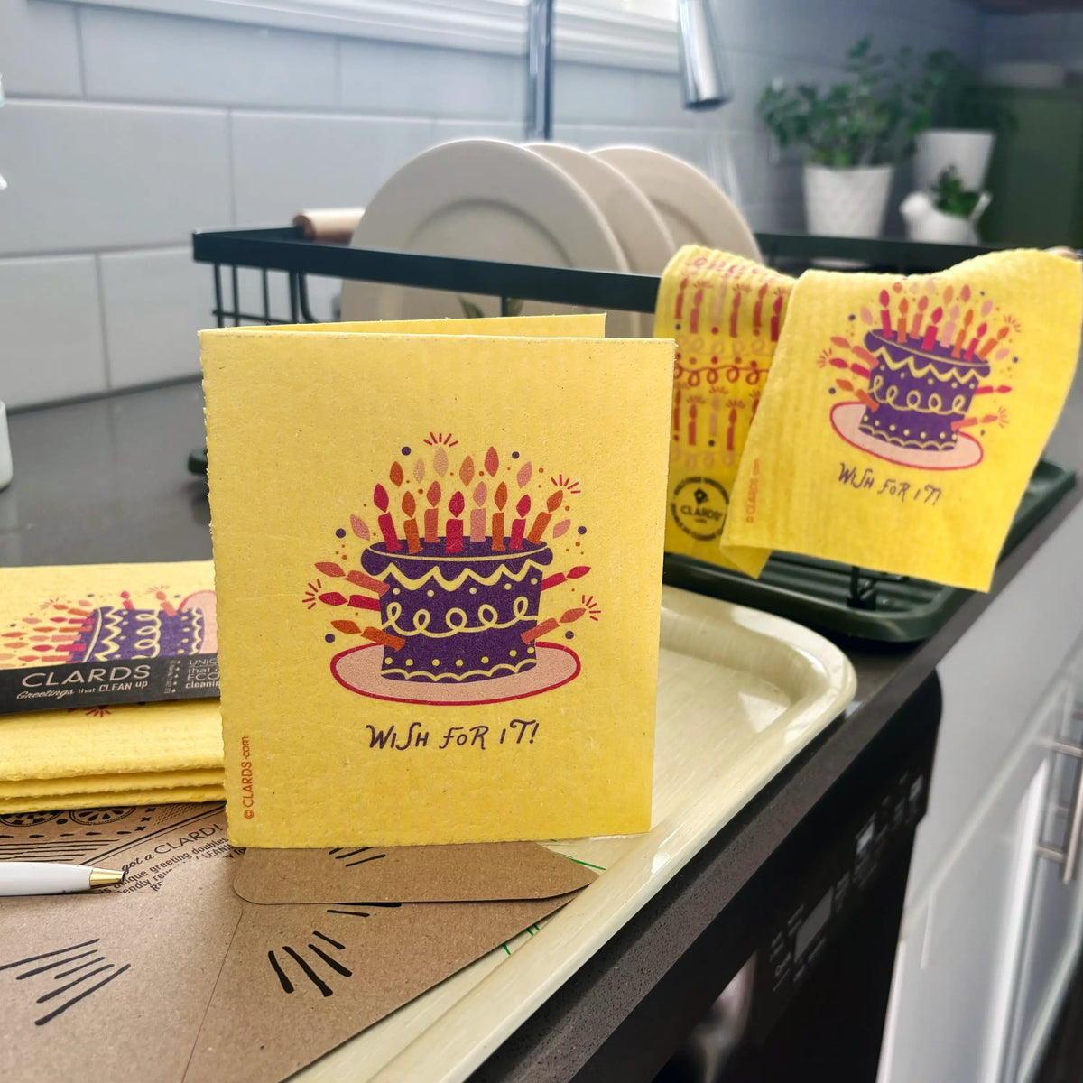 Yellow clards reusable swedish sponge cloth with purple birthday cake and colorful candles for eco cleaning
